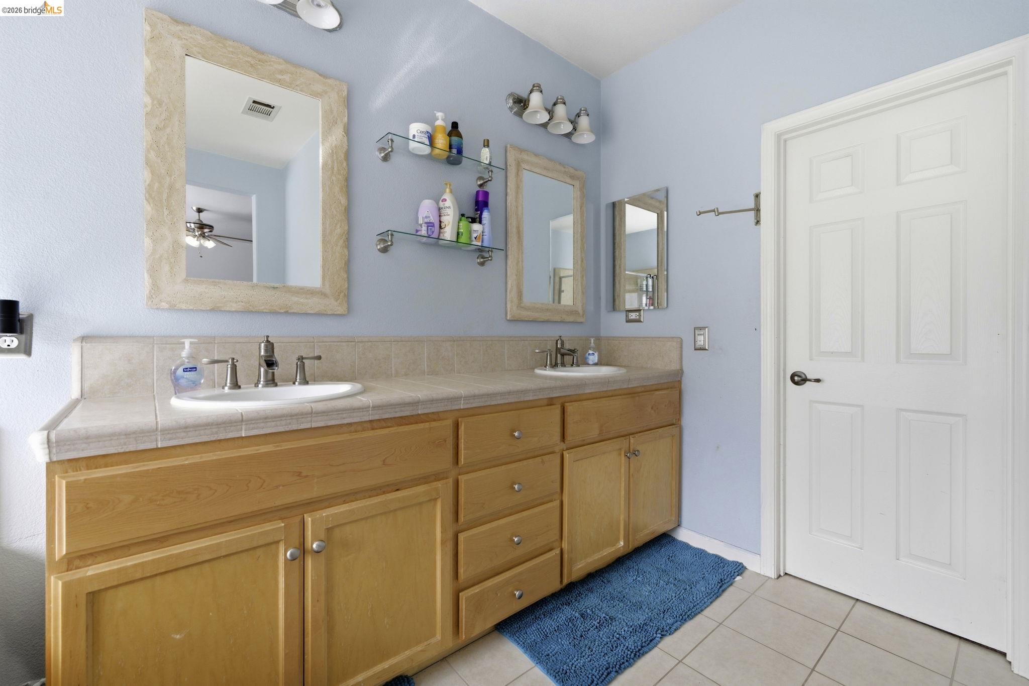 4568 Le Conte Circle Antioch, CA 94531 - Photo 13 of 36 Bathroom featuring double vanity, light tile patterned floors, and ceiling fan