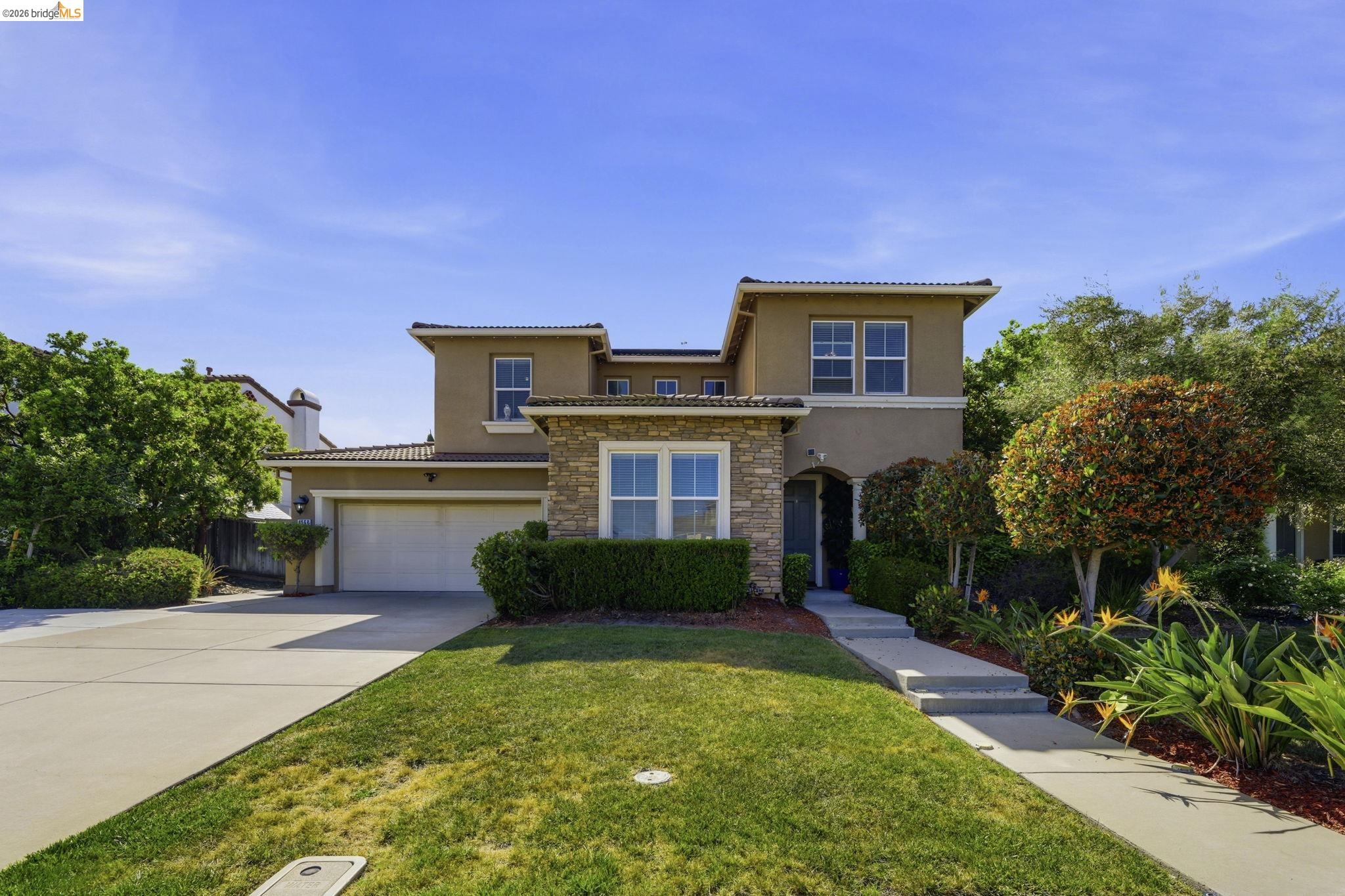 4568 Le Conte Circle Antioch, CA 94531 - Photo 3 of 36 View of front of home featuring stucco siding, stone siding, concrete driveway, a front lawn, and a garage