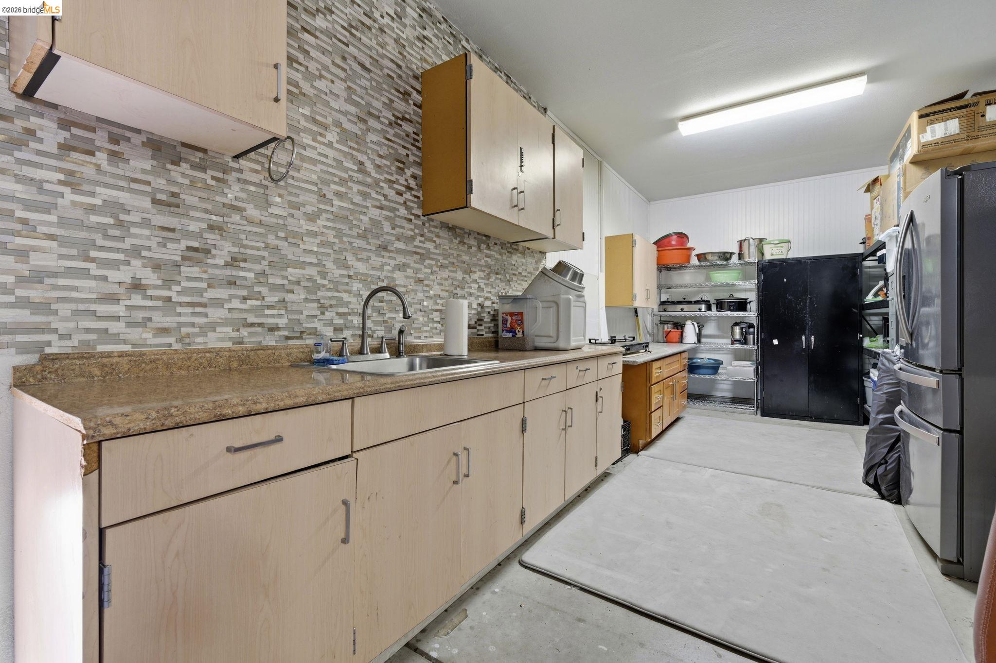 4568 Le Conte Circle Antioch, CA 94531 - Photo 34 of 36 Secondary Kitchen in garage featuring light wood finish cabinetry, light countertops, and backsplash