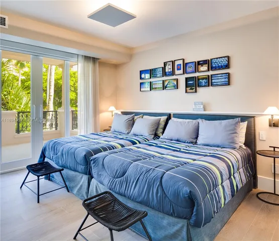 a bedroom with a bed a couch and a large window