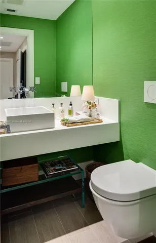 a bathroom with a sink a toilet and mirror