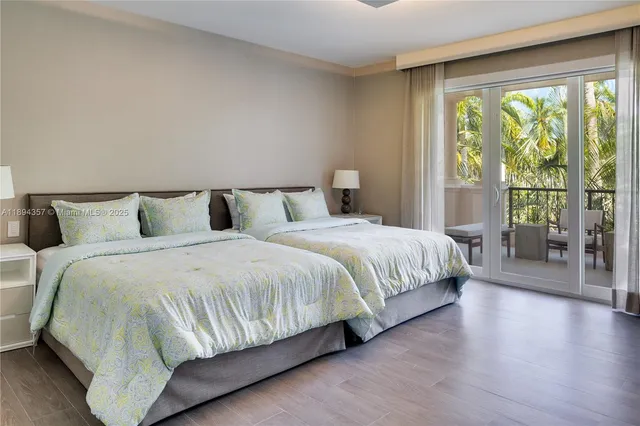 a bedroom with a large bed and a large window