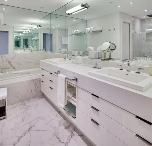 a bathroom with a double vanity sink mirror and double