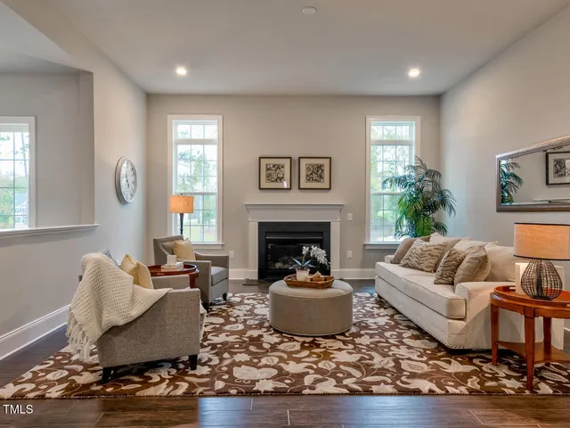 a kitchen with stainless steel appliances granite countertop a table chairs sink refrigerator and cabinets