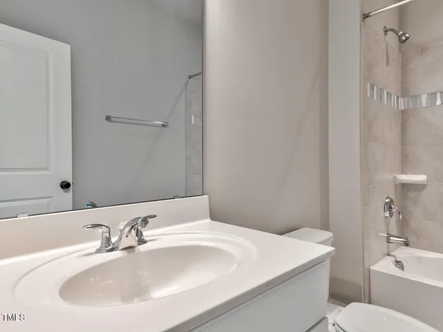 a view of a dining room with furniture a chandelier and wooden floor