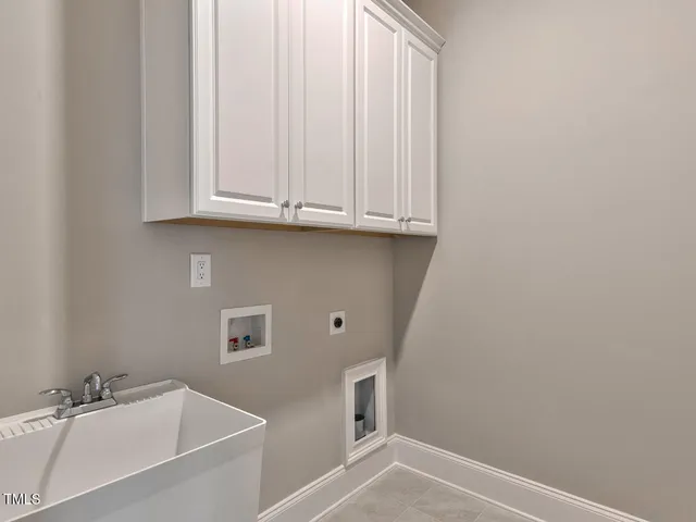a living room with furniture a large window and wooden floor