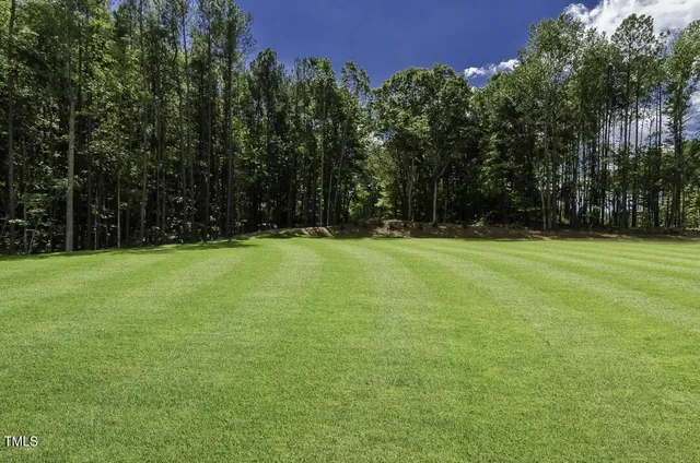 a bathroom with double vanity sink a two mirror a window a bathtub and vanity