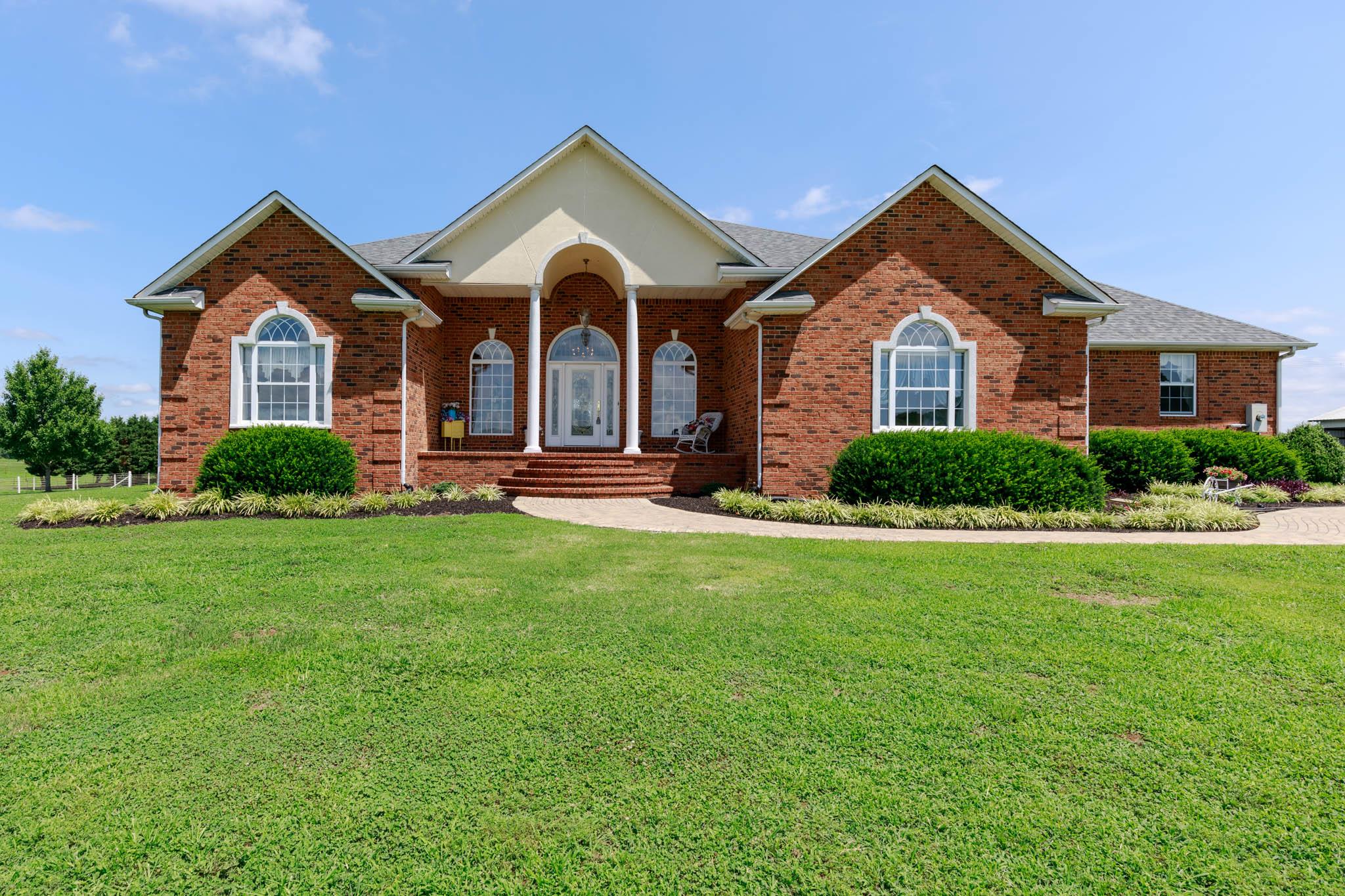 a front view of a house with a yard