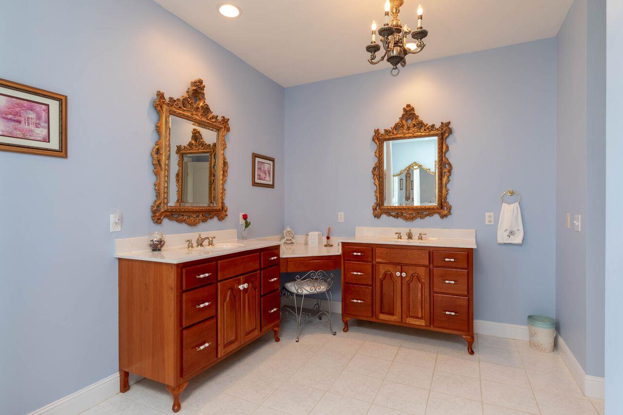 365 Normandy Road Wartrace, TN 37183 - Photo 11 of 30 a spacious bathroom with a double vanity sink large mirror and a bathtub