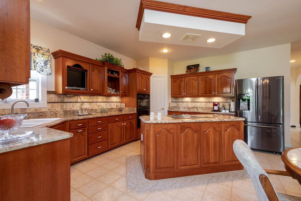 365 Normandy Road Wartrace, TN 37183 - Photo 7 of 30 a kitchen with stainless steel appliances granite countertop a sink refrigerator and microwave