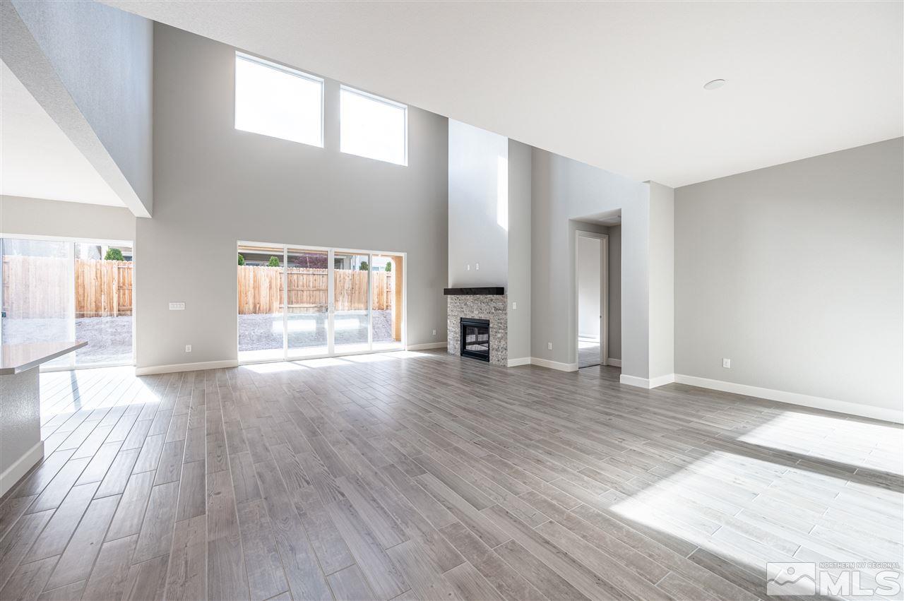 9425 Hawkshead Road, Unit HOMESITE 93 Reno, NV 89521 - Photo 2 of 11 a view of empty room with wooden floor and fireplace
