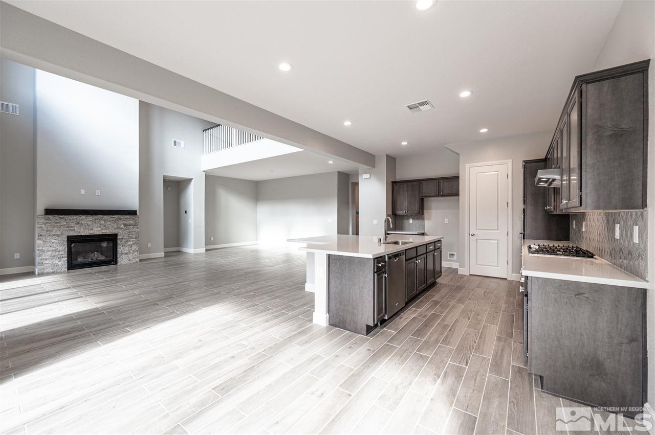 9425 Hawkshead Road, Unit HOMESITE 93 Reno, NV 89521 - Photo 5 of 11 a large kitchen with a large counter top stainless steel appliances and cabinets