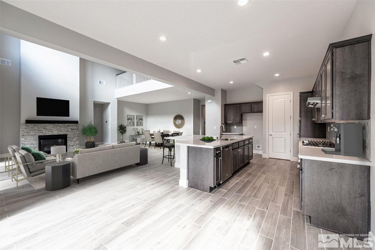 9425 Hawkshead Road, Unit HOMESITE 93 Reno, NV 89521 - Photo 6 of 11 a large living room with stainless steel appliances kitchen island a large window a couch and a couch