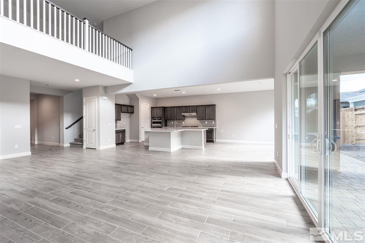 9425 Hawkshead Road, Unit HOMESITE 93 Reno, NV 89521 - Photo 7 of 11 a view of a hallway with wooden floor and a living room