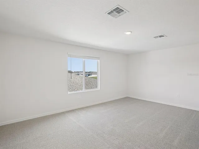 an empty room with a empty space and windows