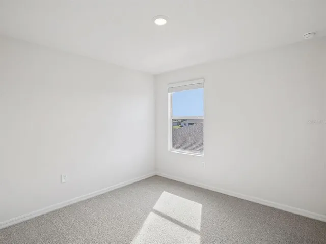 an empty room with a empty space and windows