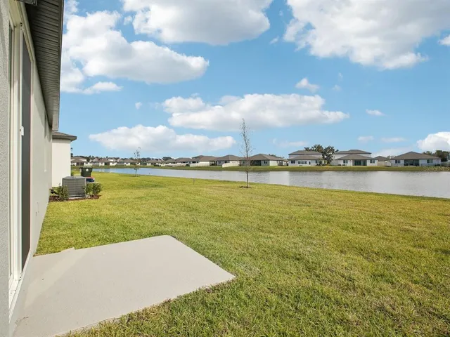 a view of a lake with houses in the back