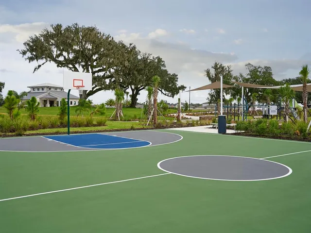 a view of a playground with basketball court