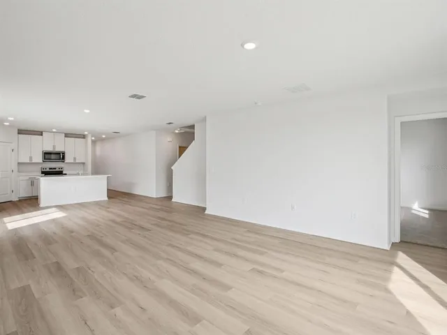 a view of a kitchen with a sink and a refrigerator