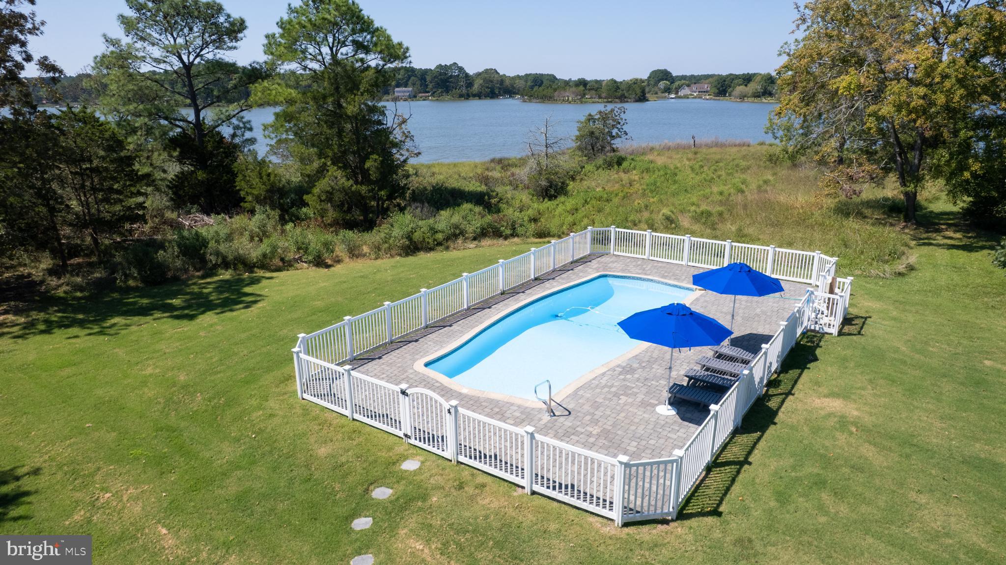 Water view inground pool with paver deck