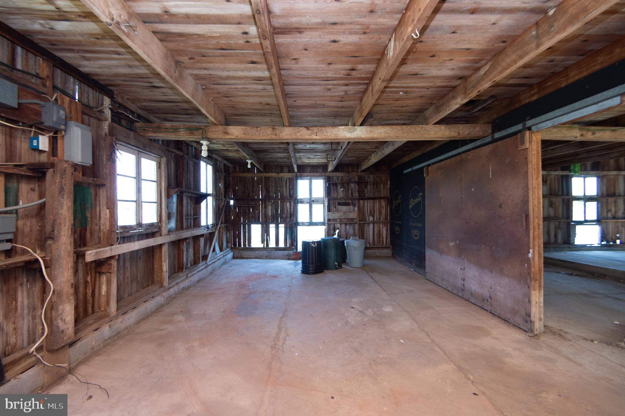 4910 Gregory Road Cambridge, MD 21613 - Photo 90 of 131 Original barn door separates outbuilding sections