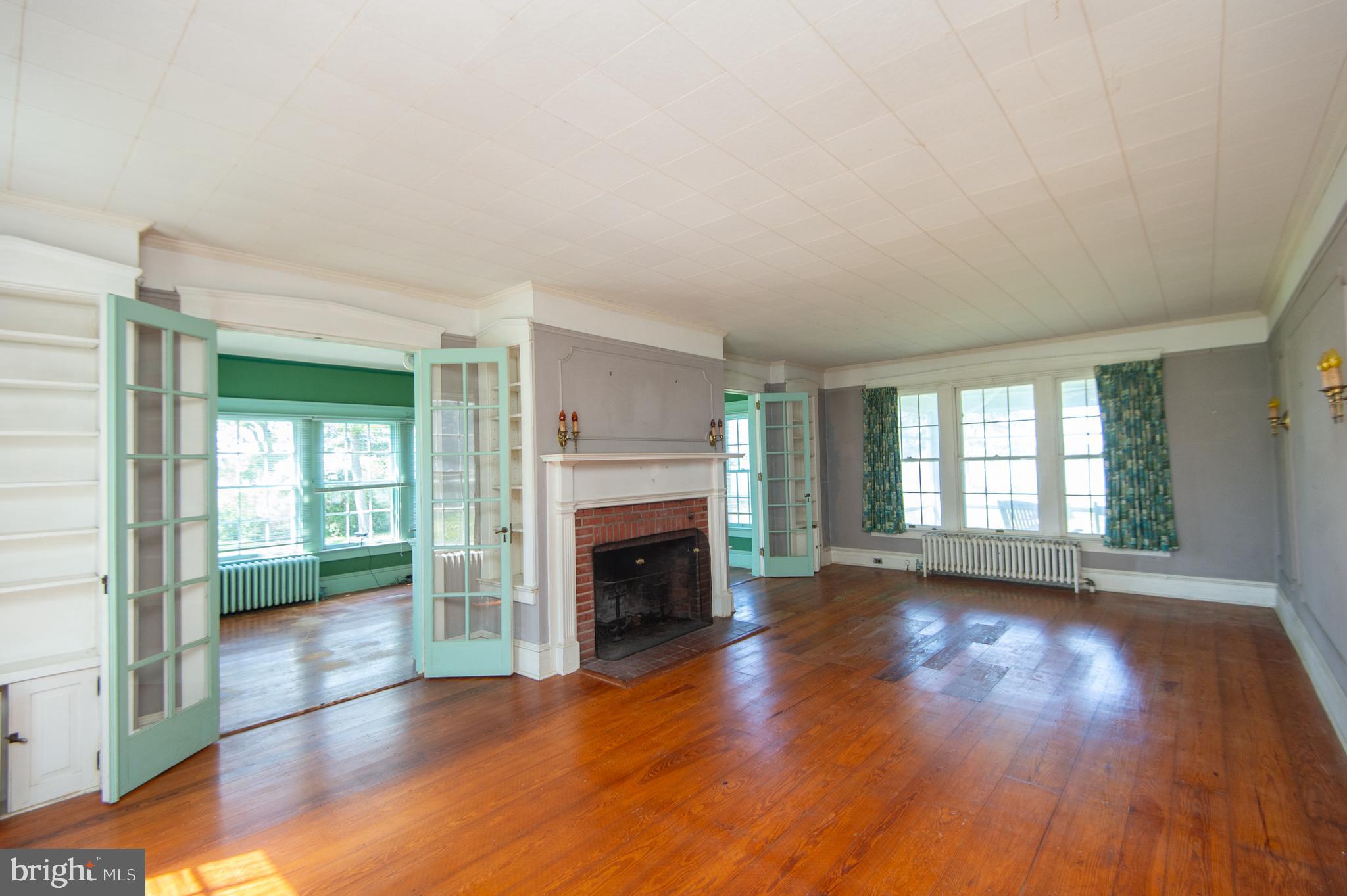 4910 Gregory Road Cambridge, MD 21613 - Photo 9 of 131 Living Room with Wood Floors & Brick Fireplace