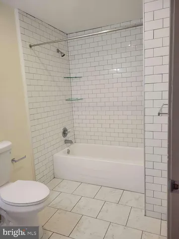 a bathroom with a bathtub and a toilet