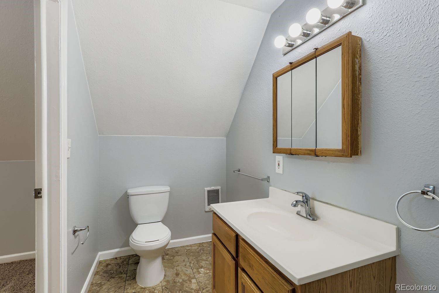 3515 North Williams Street, Unit 3517 Denver, CO 80205 - Photo 22 of 29 a bathroom with a sink toilet and mirror