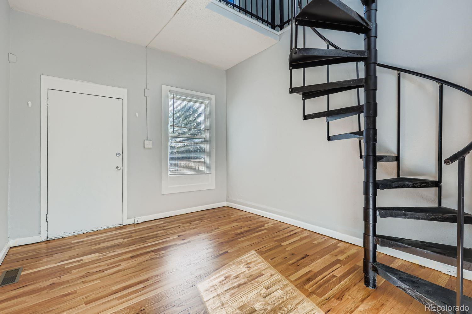 3515 North Williams Street, Unit 3517 Denver, CO 80205 - Photo 6 of 29 a view of empty room with wooden floor and fan