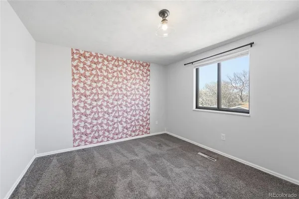 a picture of a room with a white wall and mirror