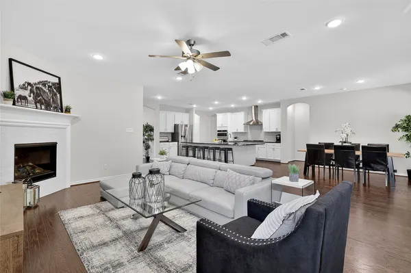 a living room with furniture a fireplace and a flat screen tv