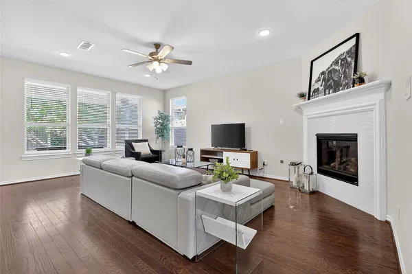 a living room with furniture fireplace and a large window