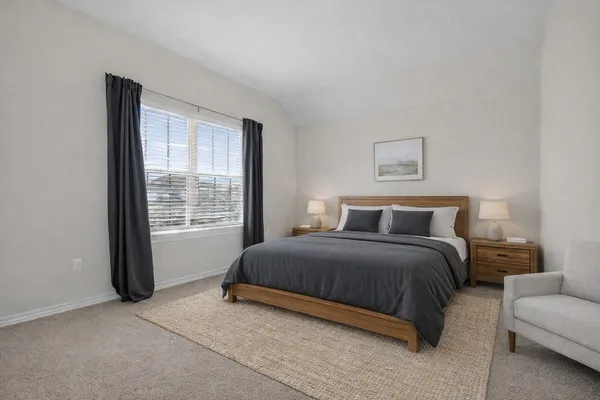 a bedroom with a bed and a window