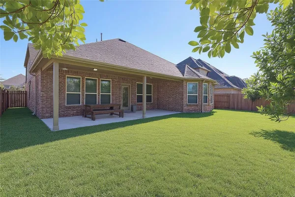an aerial view of a house with a garden and parking space