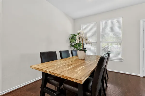 a large kitchen with a table and chairs