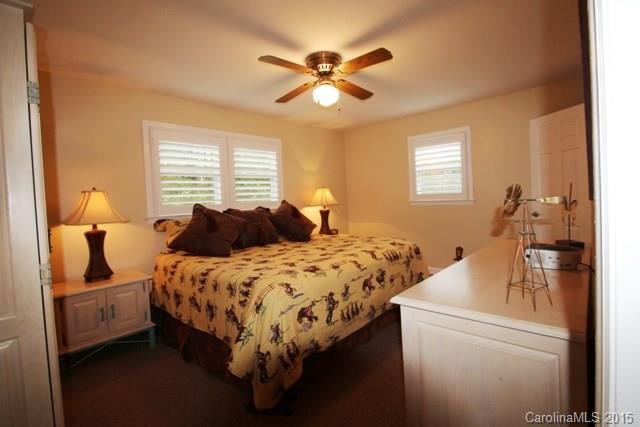 1424 Tot Dellinger Road Cherryville, NC 28021 - Photo 13 of 24 a bedroom with a bed and a chandelier