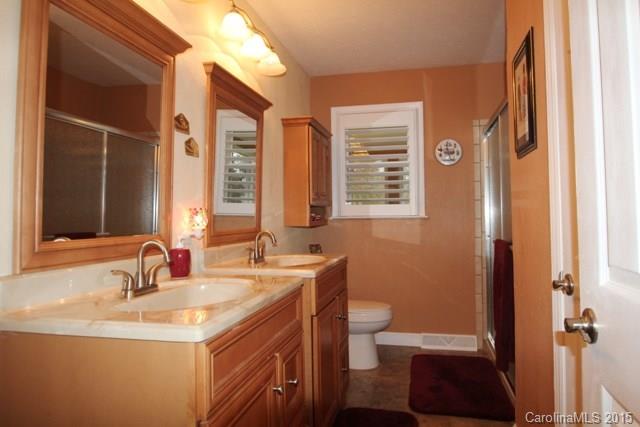 1424 Tot Dellinger Road Cherryville, NC 28021 - Photo 20 of 24 a bathroom with a sink a toilet and a large mirror