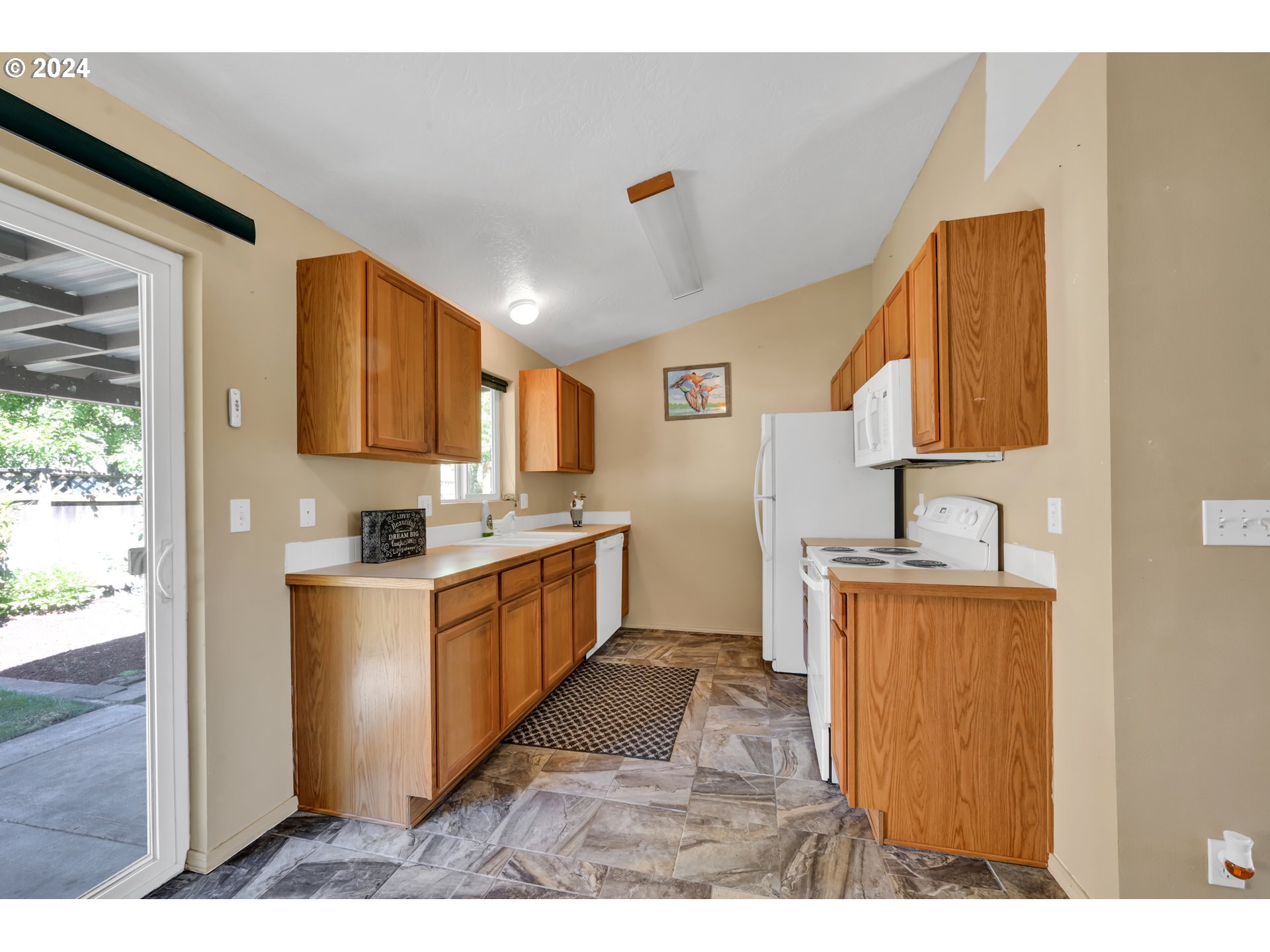 870 Hazelnut Lane Springfield, OR 97478 - Photo 13 of 35 a kitchen with stainless steel appliances granite countertop a sink and a refrigerator
