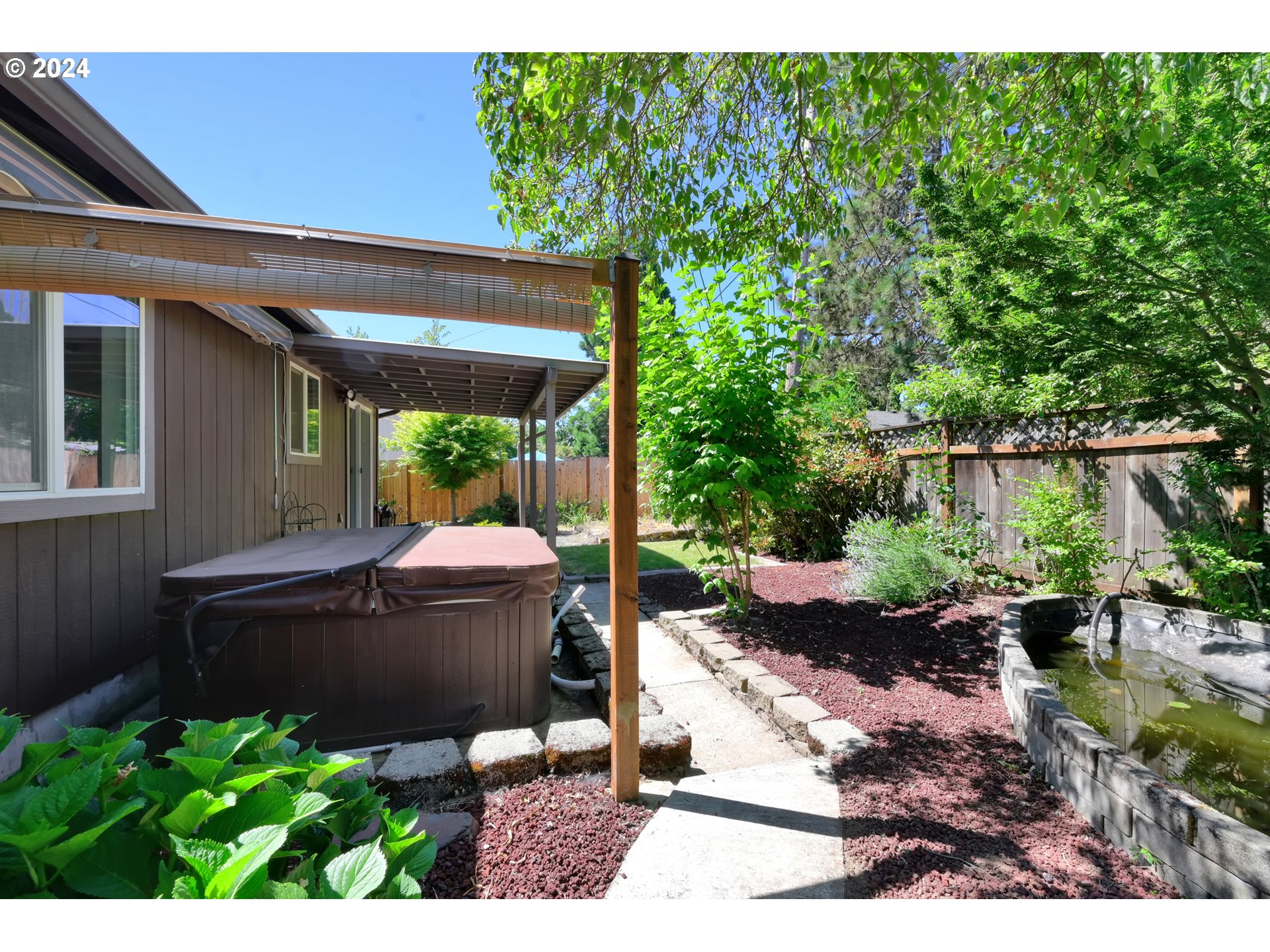 870 Hazelnut Lane Springfield, OR 97478 - Photo 30 of 35 a view of a patio with table and chairs potted plants and large tree