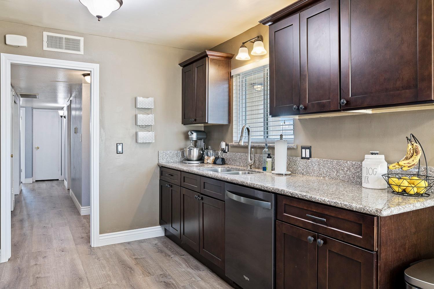 5780 North Angus Street Fresno, CA 93710 - Photo 11 of 41 a kitchen with stainless steel appliances granite countertop a sink stove and cabinets