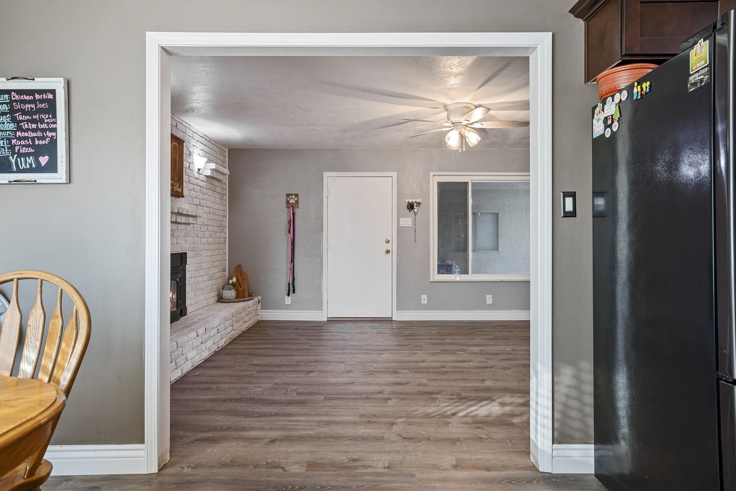 5780 North Angus Street Fresno, CA 93710 - Photo 17 of 41 a view of a hallway with wooden floor and a chandelier