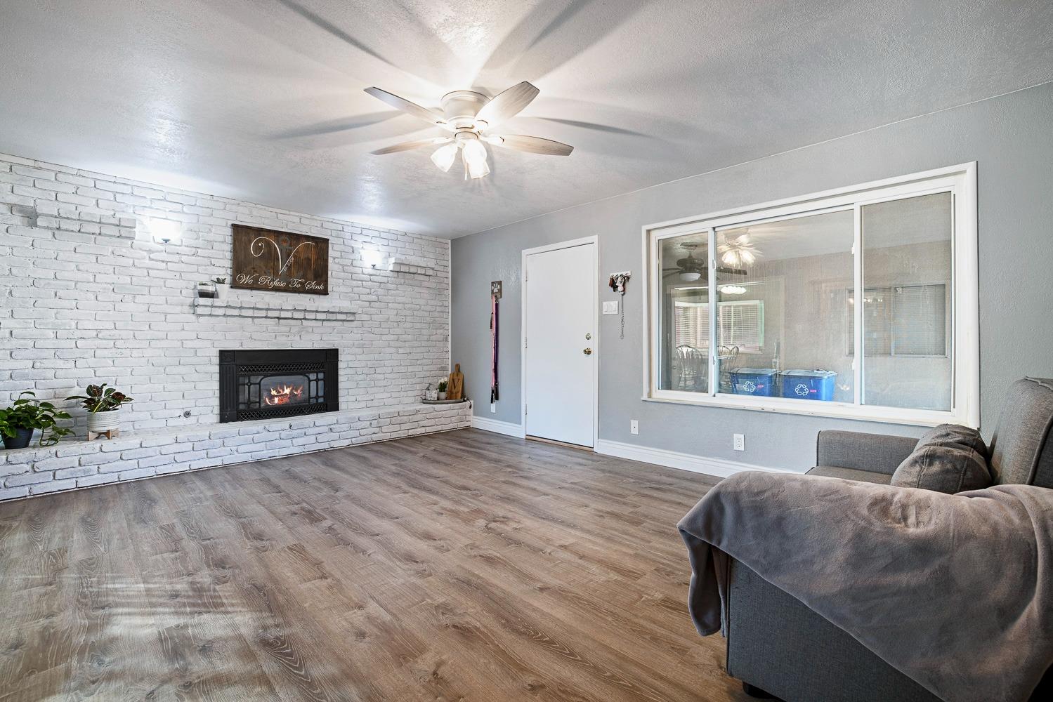 5780 North Angus Street Fresno, CA 93710 - Photo 19 of 41 a living room with furniture and a fireplace