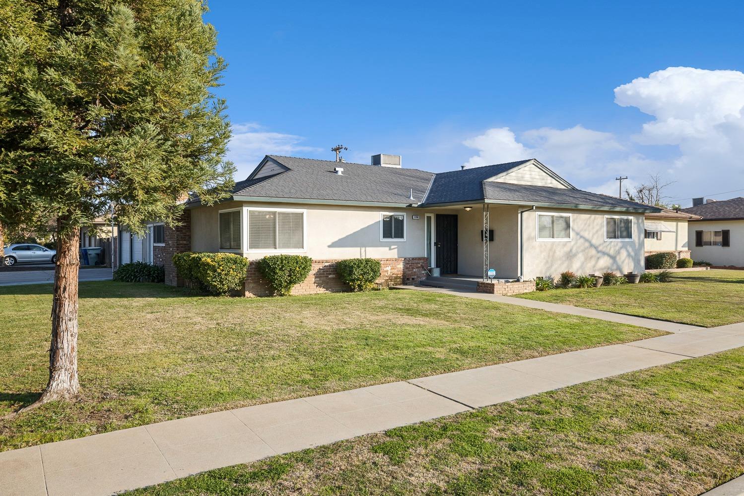 5780 North Angus Street Fresno, CA 93710 - Photo 2 of 41 a front view of a house with a yard