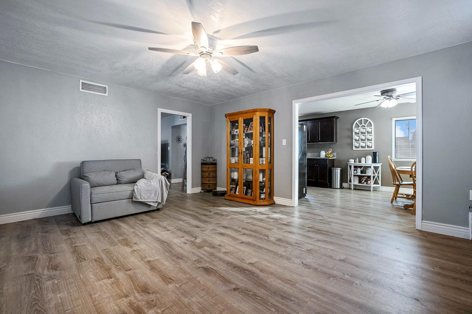5780 North Angus Street Fresno, CA 93710 - Photo 21 of 41 a living room with furniture and a wooden floor