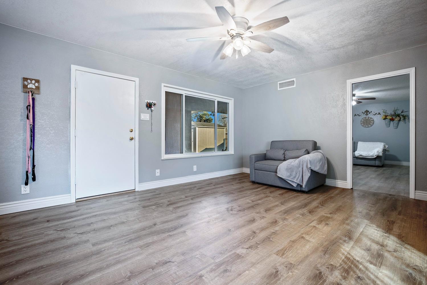 5780 North Angus Street Fresno, CA 93710 - Photo 22 of 41 a living room with furniture and a chandelier