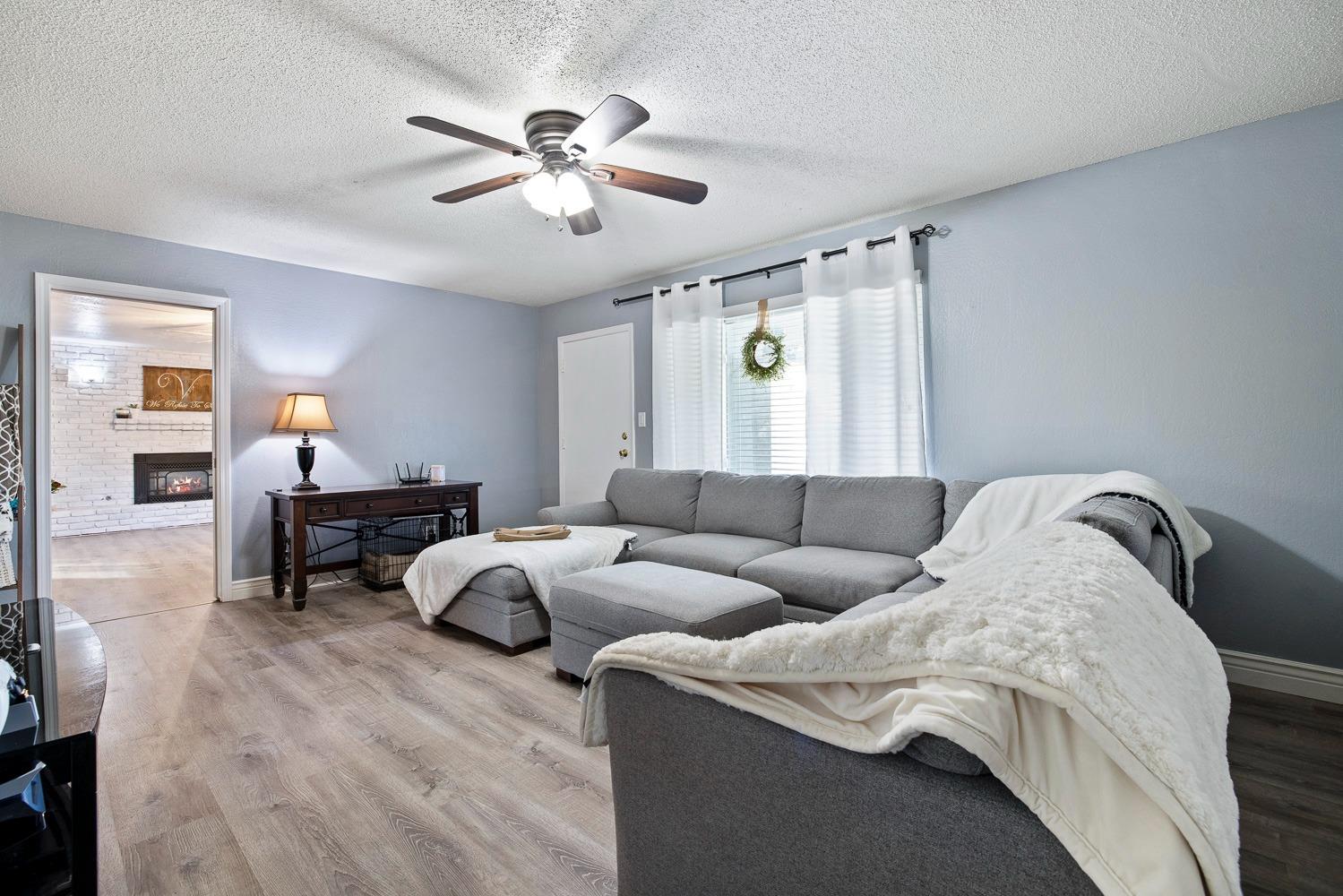 5780 North Angus Street Fresno, CA 93710 - Photo 23 of 41 a living room with furniture and wooden floor