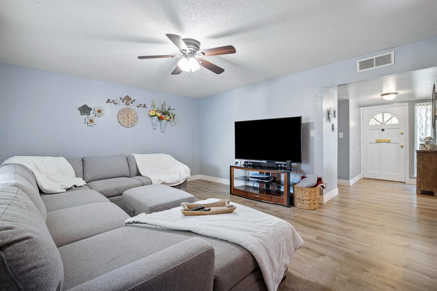 5780 North Angus Street Fresno, CA 93710 - Photo 24 of 41 a living room with furniture and a flat screen tv
