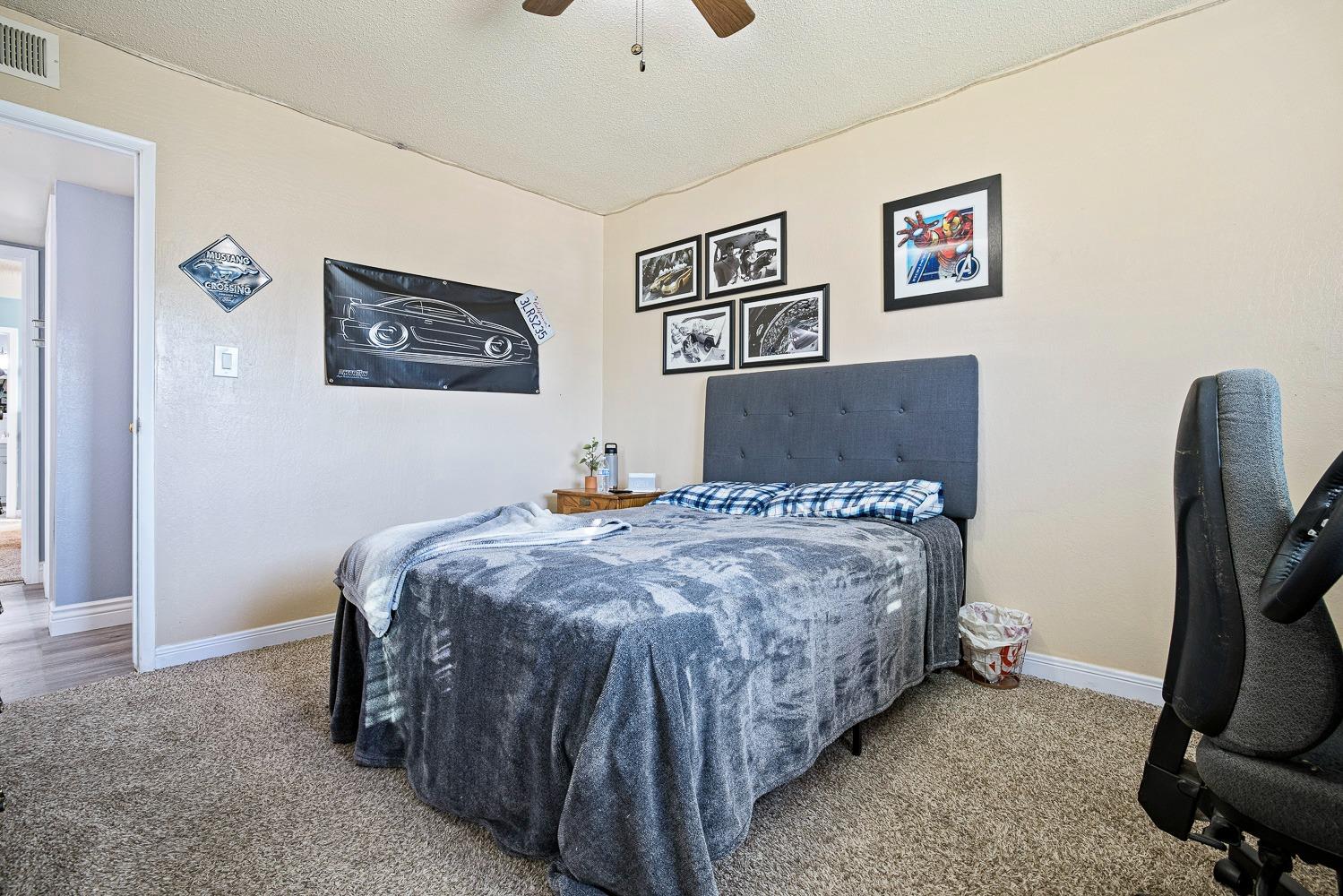 5780 North Angus Street Fresno, CA 93710 - Photo 30 of 41 a bed sitting in a bedroom next to a window