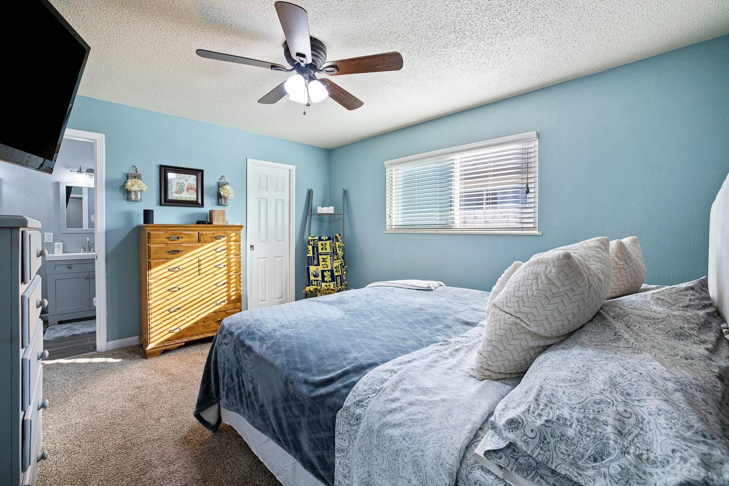 5780 North Angus Street Fresno, CA 93710 - Photo 31 of 41 a bedroom with a bed and a flat screen tv