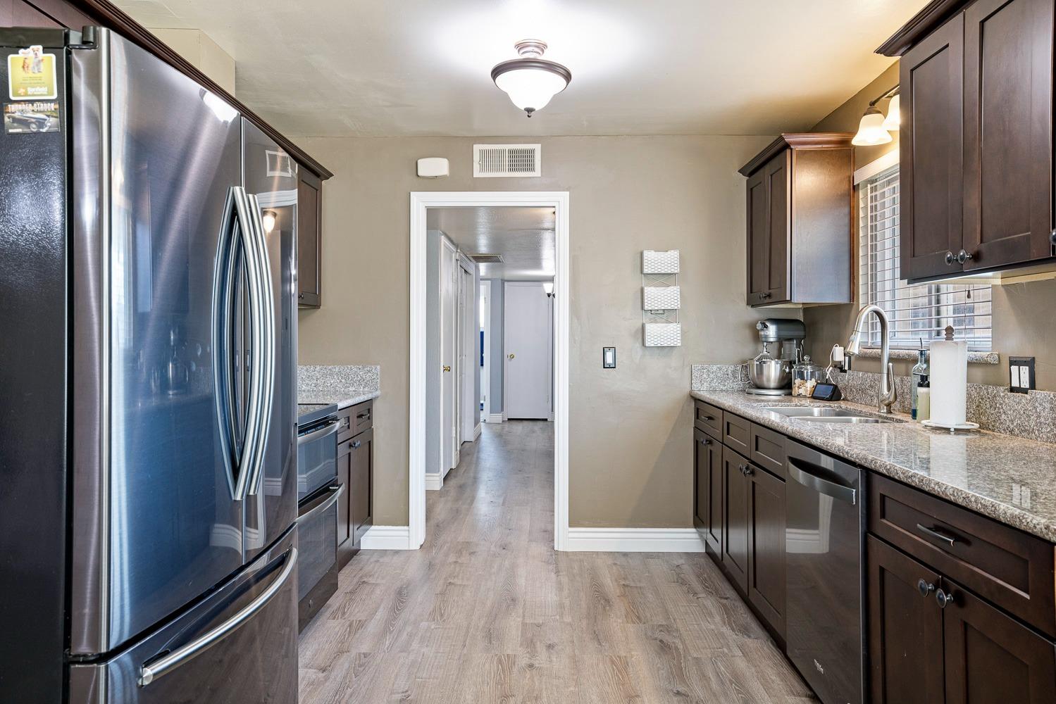 5780 North Angus Street Fresno, CA 93710 - Photo 9 of 41 a kitchen with stainless steel appliances granite countertop a refrigerator a sink and dishwasher